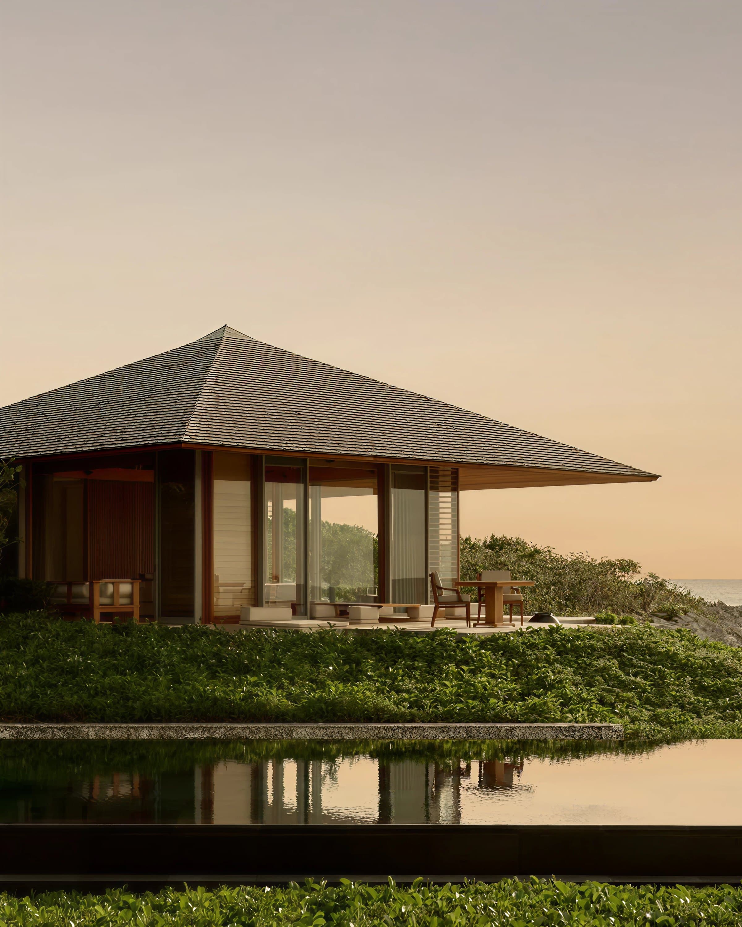 A pavilion residence at dusk overlooking the coastline